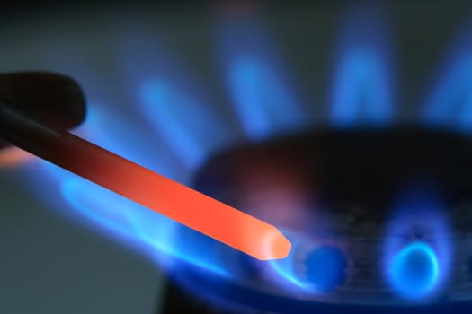 Dark background with white-hot nail and blue gas flame