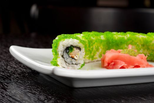 Sushi rolls made of salmon, avocado, flying fish roe - tobiko caviar and philadelphia cheese