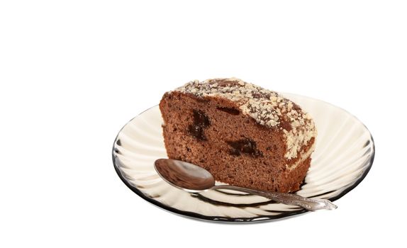 Piece of chokolate fancy cake on glass spoon. Isolated on white with clipping path