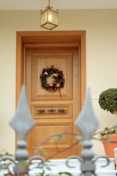Christmas Wreath hanging on the door of nice modern house