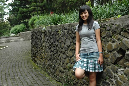 young asian lady stand up in the park