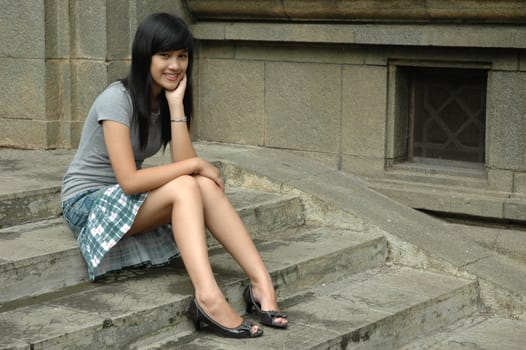 young asian lady sit down in park