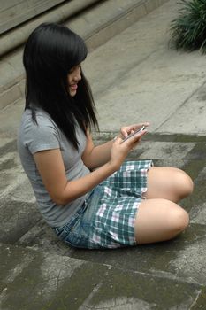 young asian lady sit down in park