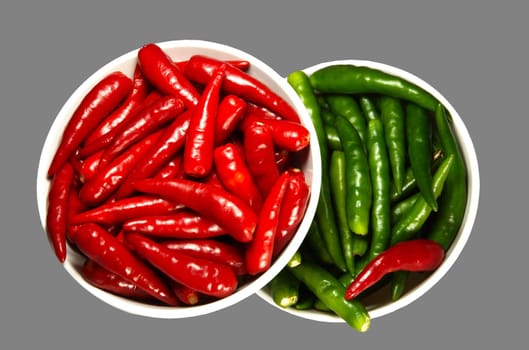 Red and Green Spicy chili pepper in the plate. Isolated on white