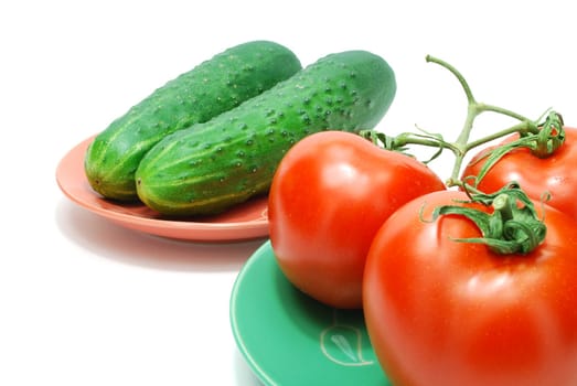 Three Red Tomatoes  and Two Cucumbers on Plate