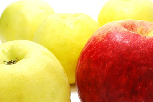 Red Leader Apple between Yellow Apples Isolated on White