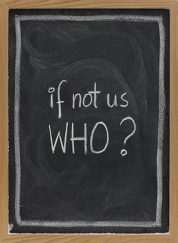 if not us, who - question handwritten with white chalk on blackboard, eraser smudge patterns