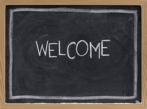 welcome - white chalk handwriting on blackboard with eraser smudge texture