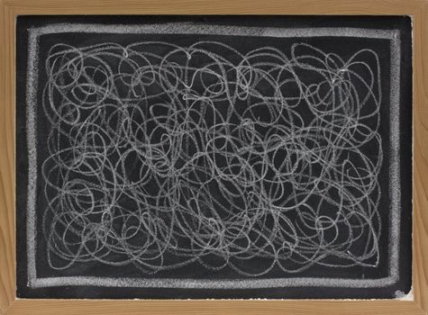 child art - white chalk chaotic scribble abstract on blackboard 