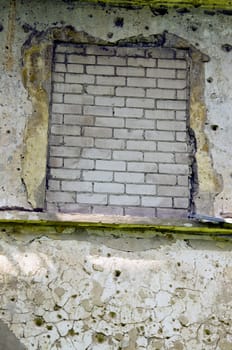 Window mure up with white bricks. Neglected architectural image.