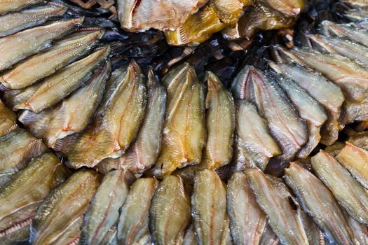 Dried fish in a circle on plate.