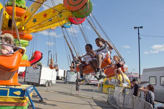 Kids riding the Merry go Round at the 2011 Queen City Ex