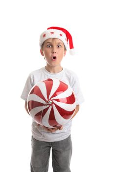 Child holding a large Christmas bauble.