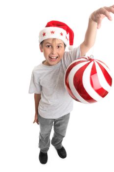 Childs arm stretched up high with a large bauble dangling from fingers