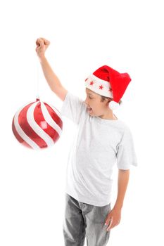 A child enjoying the Christmas season holdss up a big bauble