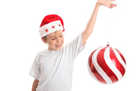 A child watches a large Christmas  bauble spin around with much delight..