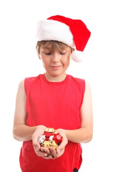 A boy holds a handful of festive gold, silver and red foil wrapped chocolate stars