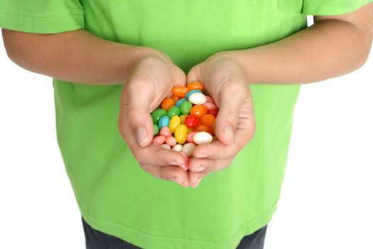 Child's hands holding a handful of lollies.