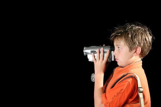 Boy filming using a home video camera,  camcorder.