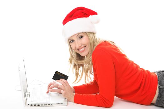 Girl using a card to shop safely  online.  She has a card in one hand and is looking up and smiling.  Change the text or add in your own card or credit card.