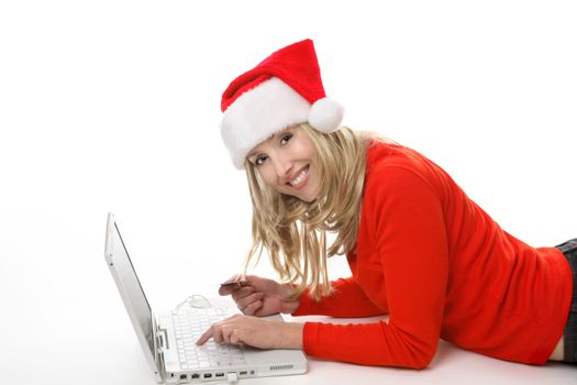 A female using a laptop and shopping online buying  gifts at Christmastime.