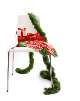 White chair with gifts and garland on white background