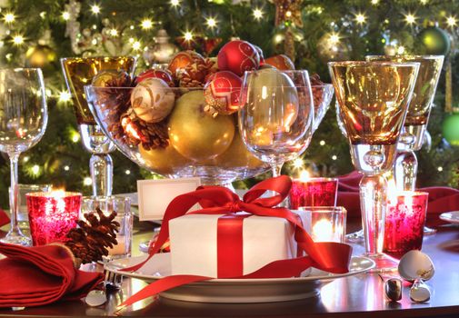 Elegant  holiday table setting with red ribbon gift