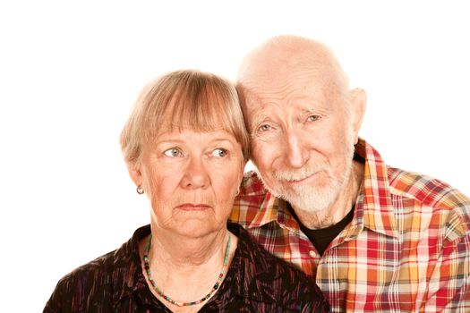 Portrait of concerned senior couple on white background
