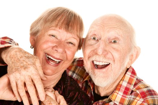 Happy senior couple on white background laughing broadly