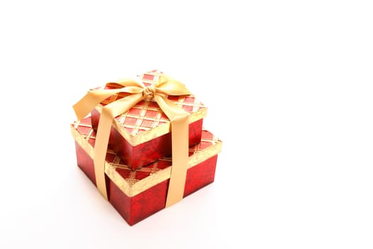 Red and metallic gold gift tield with satin ribbon on white background.