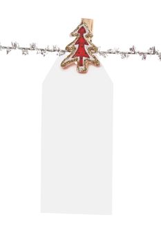 One single large  christmas tag  pegged to a silver line