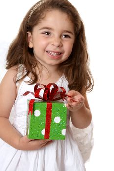 Pretty little girl holding a present and smiling.   