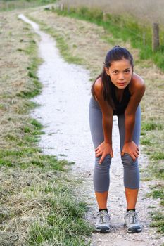 Workout. Woman resting of running outside. Beautiful mixed race young woman.