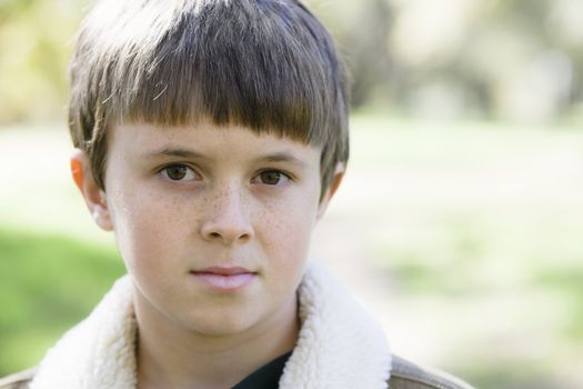 Portrait of a Cute Young Boy Looking Directly To Camera