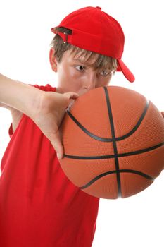 Closeup of a  young active boy playing with a basketball