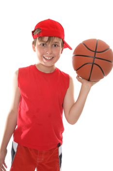 Hot, smiling child holding a basketball in one hand after play.