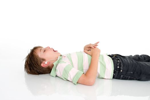 Child lying down listening to mp3 music