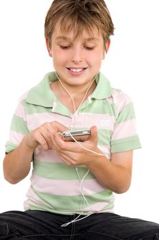 Child sitting down using a digital player.  He is wearing a striped polo shirt and jeans.