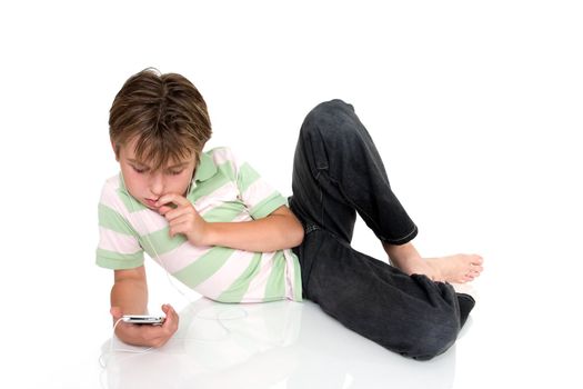 Child relaxing with electronic music player.
