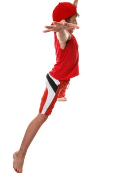 An active fit  boy doing star jumps - side profile.