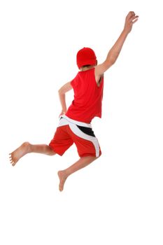 Boy jumps hand raised  in the air.  Jump for joy, leap of faith, etc, fitness, fun or concept.  There is a little bit of motion in the arm and feet at full size..