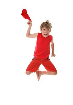 A boy with zestful energy jumps high off the floor and takes off his hat.