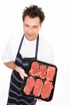 Butcher showing a tray of tender scotch filet steak.