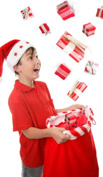 Lots of presents fall into a young boys Christmas sack to his delight. Some motion visible in presents.