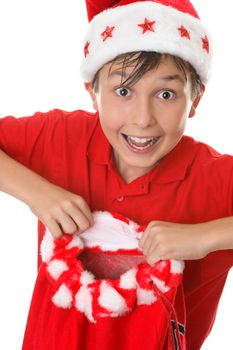 Merry boy holding a red toy sack for presents at Christmas