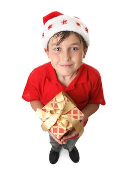 A child lookign up and holding a red and gold gift