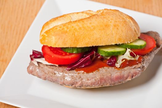 steak sandwich on a white plate