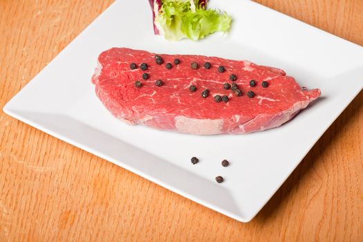 raw steak prepared for cooking