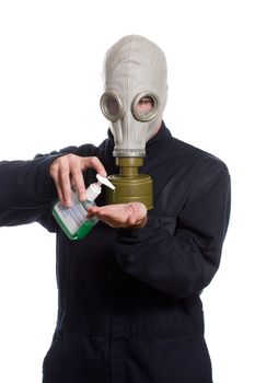 A young man wearing a breathing apparatus is using some hand sanitizer to keep germs away, isolated against a white background
