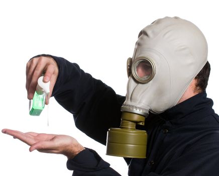 Closeup view of a man wearing a gas mask using some hand sanitizer to kill any germs, isolated against a white background
